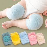 Infant wearing breathable cotton non-slip knee pads while crawling on hardwood floor.