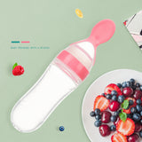 2-in-1 silicone baby feeder spoon bottles lined up in pastel pink, yellow, green, blue, and white.