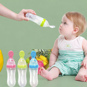 Silicone baby squeeze feeding spoon bottle in soft white showing the 90ml scale measurement.